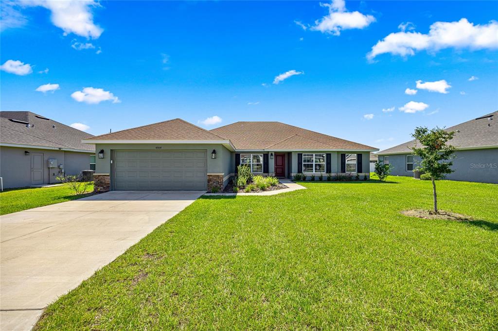 a front view of a house with a yard and garage