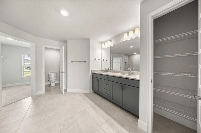 a large bathroom with a sink and a mirror