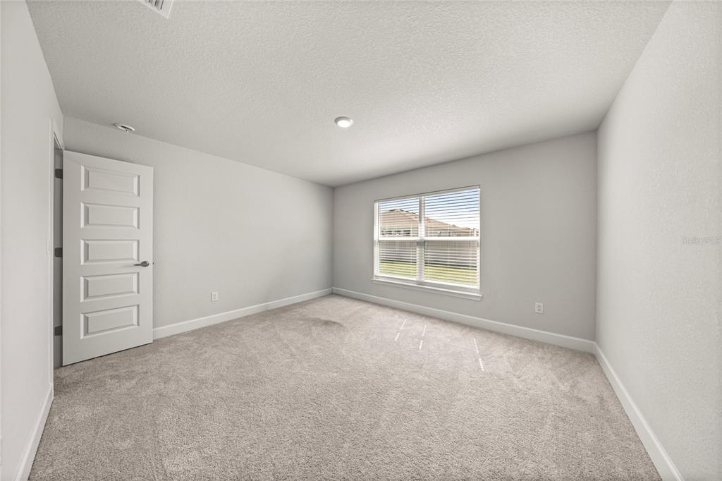 4984 Southwest 91st Place Ocala, FL 34476 - Photo 32 of 42 an empty room with windows and closet