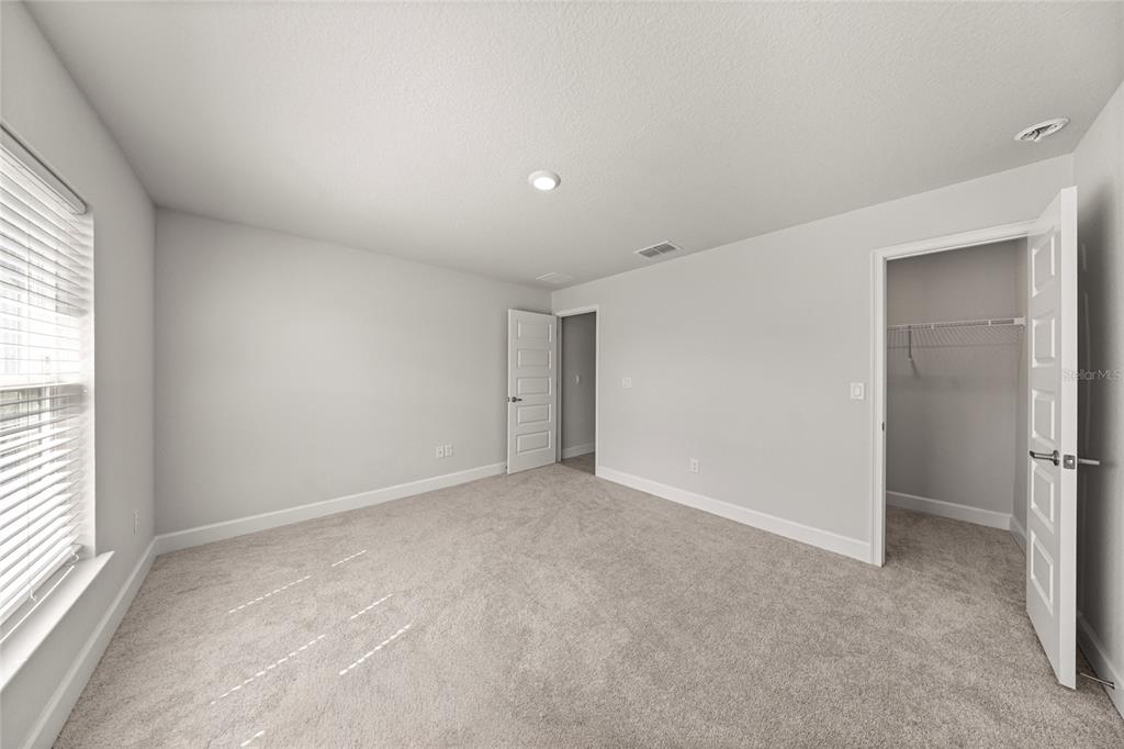 4984 Southwest 91st Place Ocala, FL 34476 - Photo 34 of 42 an empty room with a natural light