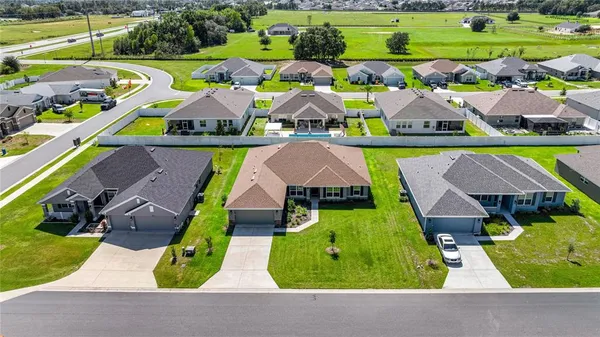 an aerial view of multiple houses with yard