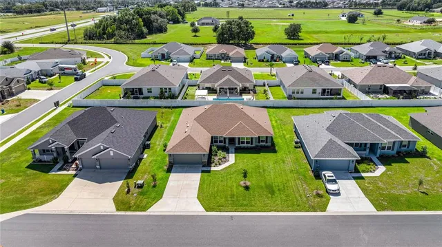 an aerial view of multiple houses with yard