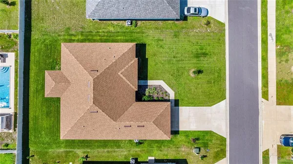 an aerial view of a house with a yard