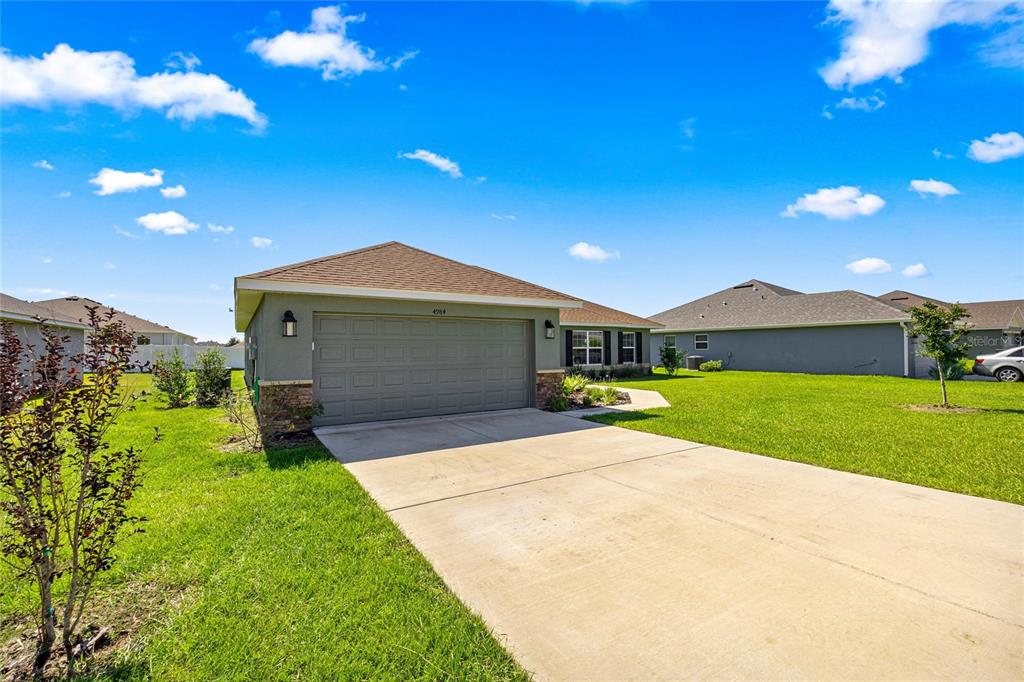 4984 Southwest 91st Place Ocala, FL 34476 - Photo 6 of 42 a front view of a house with yard and large tree