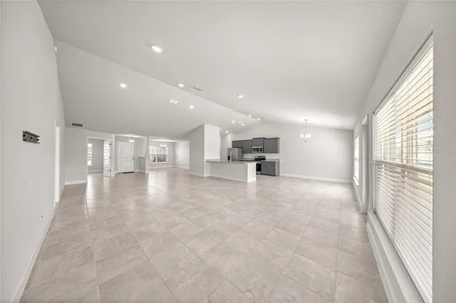 a view of kitchen with kitchen island and a window