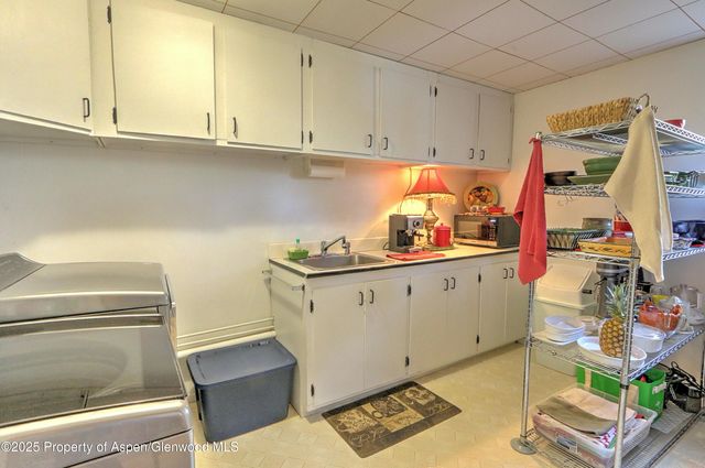 a kitchen with stainless steel appliances cabinets and a table