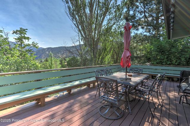 a view of balcony with wooden floor and outdoor seating