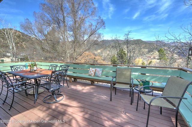 a view of a chairs and table in patio