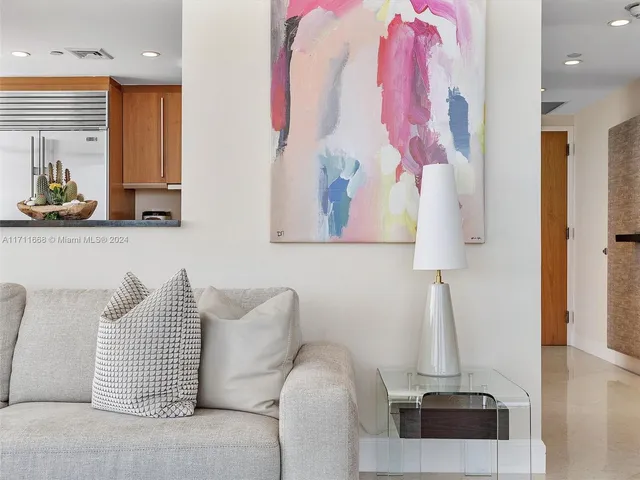 a view of a balcony with chairs and floor to ceiling window