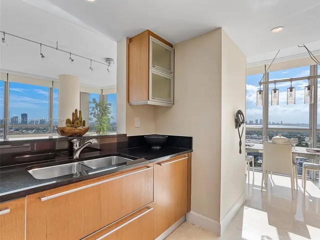 a bedroom with a bed and large window