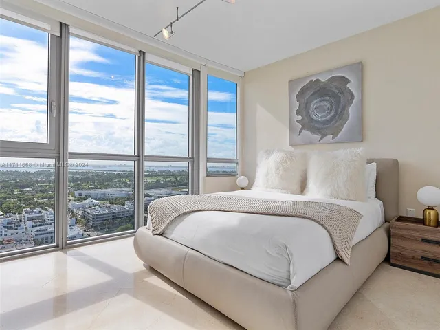 a bedroom with bed and window