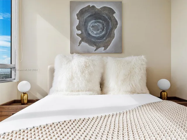 a bedroom with a bed lamp and table