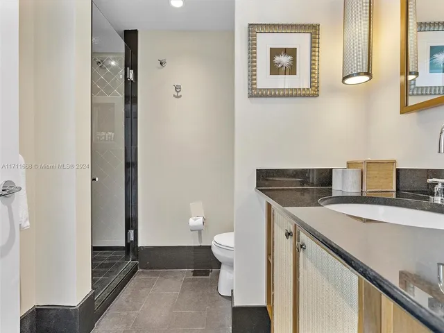 a bedroom with a large bed and a large window