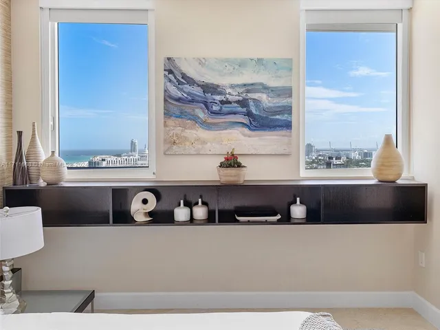 a living room with lots of furniture and a view of kitchen