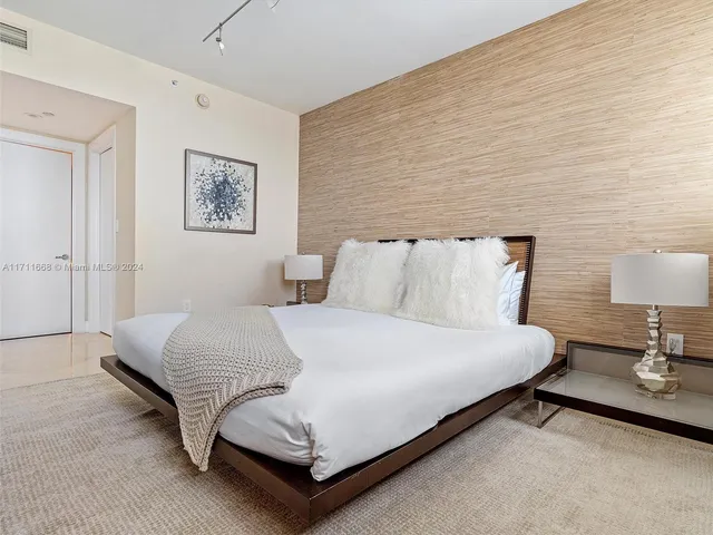 a living room with furniture and floor to ceiling windows