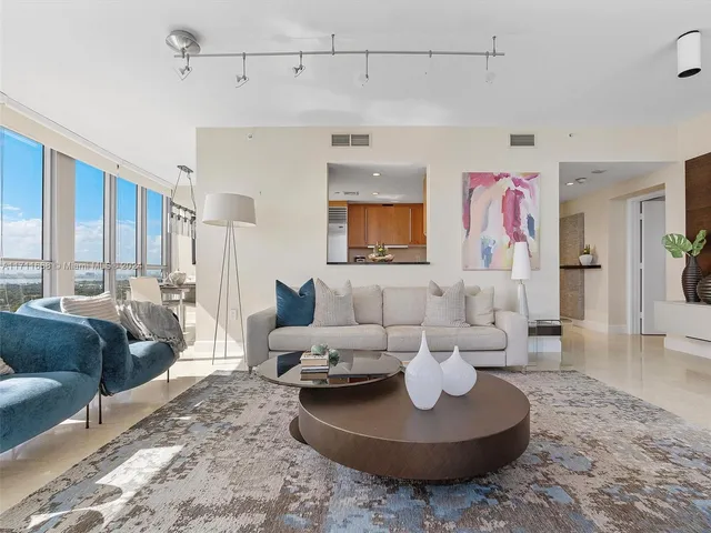 a living room with furniture and a rug