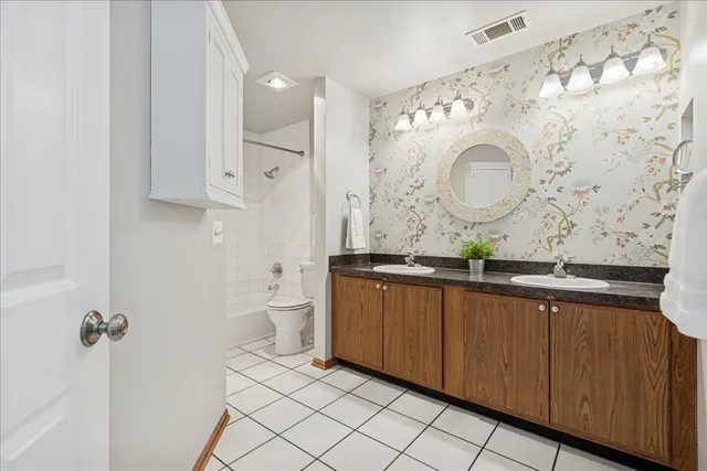 a bathroom with a double vanity sink and a mirror