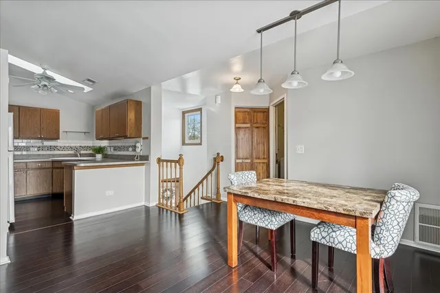 a kitchen with granite countertop a stove a sink and a refrigerator