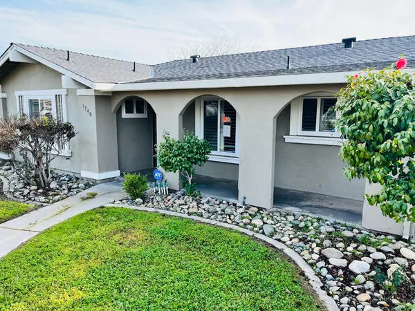 a front view of house with yard and outdoor seating