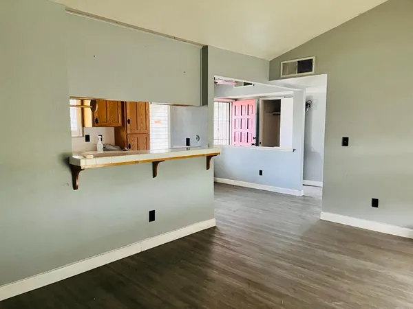 a room with a wooden floor and white walls