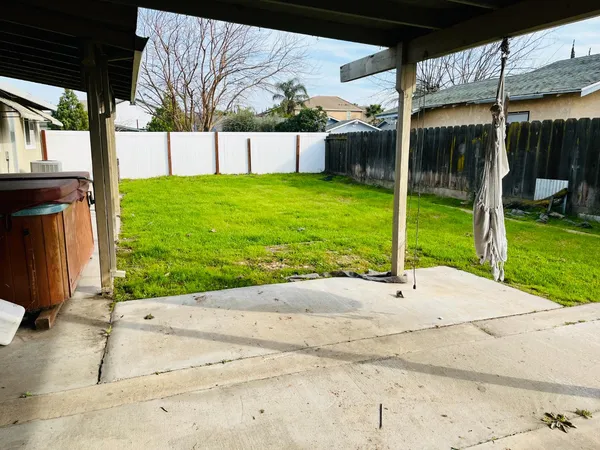 a view of a house with backyard and porch