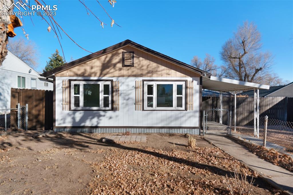 1007 Sunset Road Colorado Springs, CO 80909 - Photo 1 of 32 a front view of a house with yard