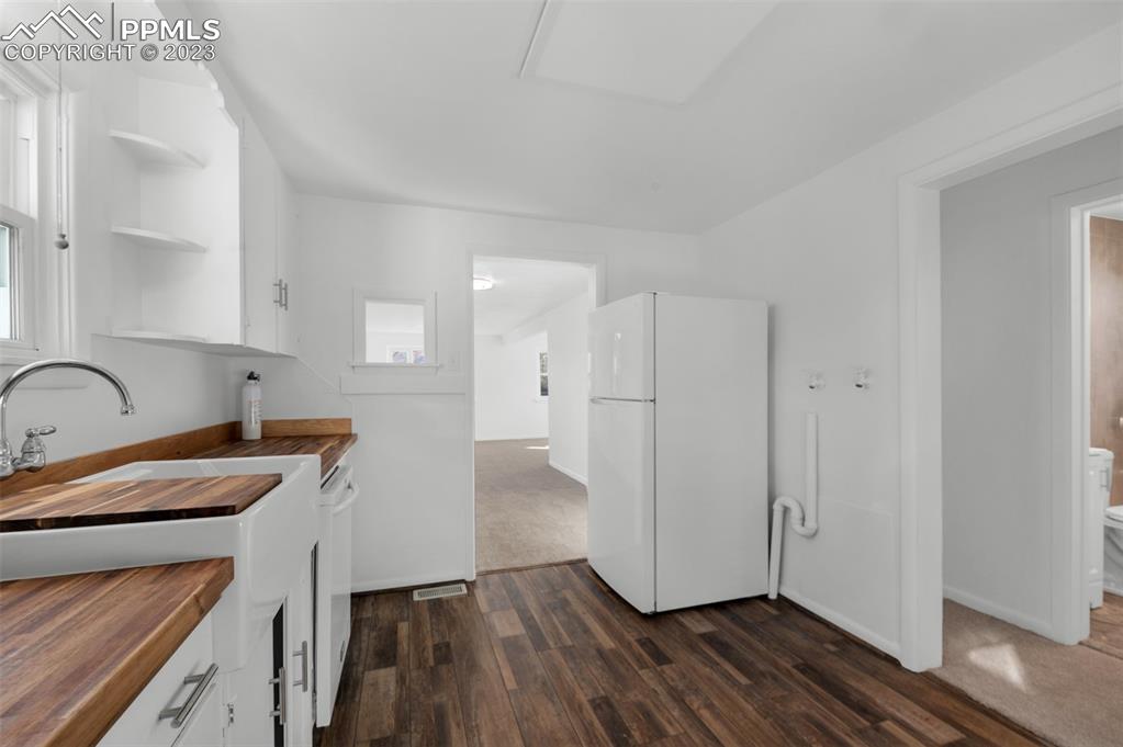 1007 Sunset Road Colorado Springs, CO 80909 - Photo 13 of 32 a view of a kitchen with wooden floor
