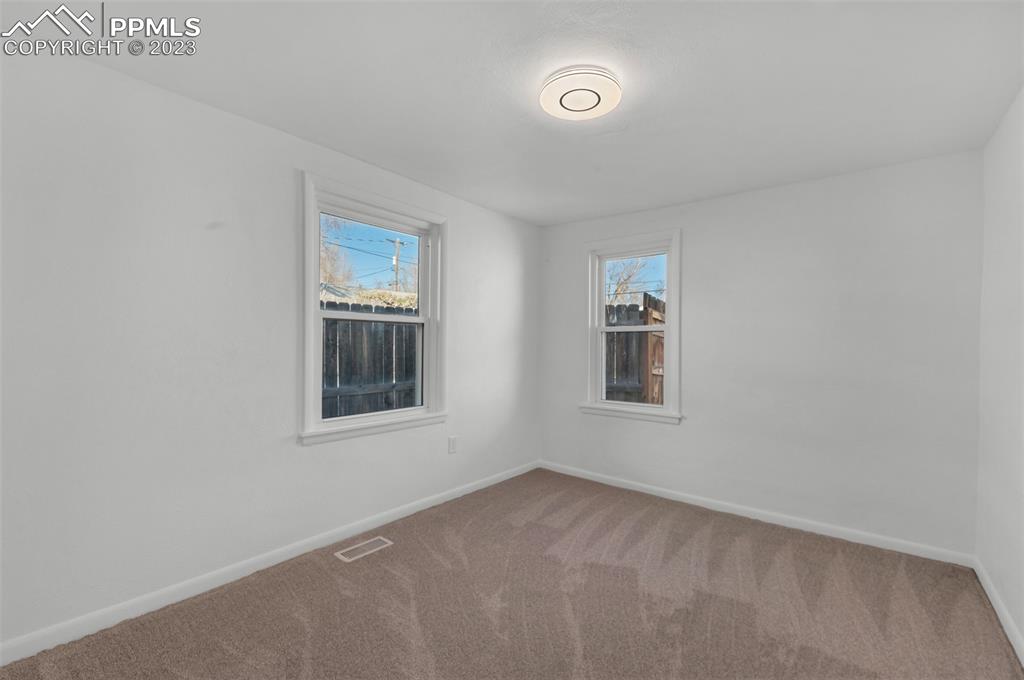 1007 Sunset Road Colorado Springs, CO 80909 - Photo 18 of 32 an empty room with a window