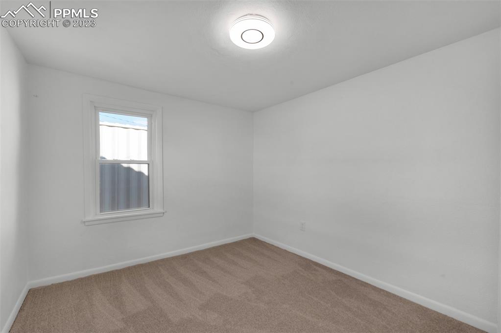 1007 Sunset Road Colorado Springs, CO 80909 - Photo 19 of 32 an empty room with a window