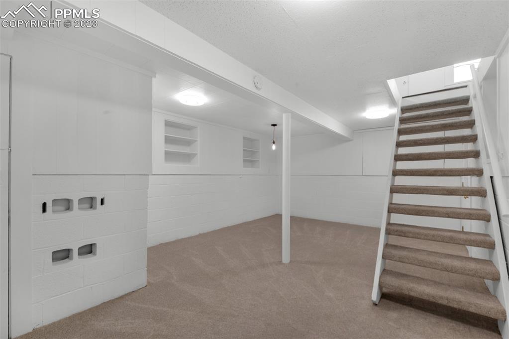 1007 Sunset Road Colorado Springs, CO 80909 - Photo 23 of 32 a view of an empty room with stairs