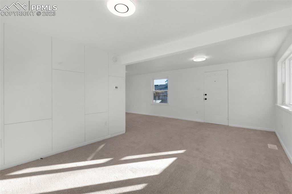 1007 Sunset Road Colorado Springs, CO 80909 - Photo 6 of 32 a view of a livingroom with an empty space