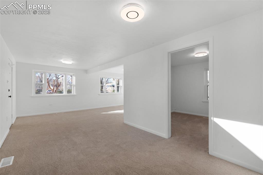 1007 Sunset Road Colorado Springs, CO 80909 - Photo 9 of 32 an empty room with windows