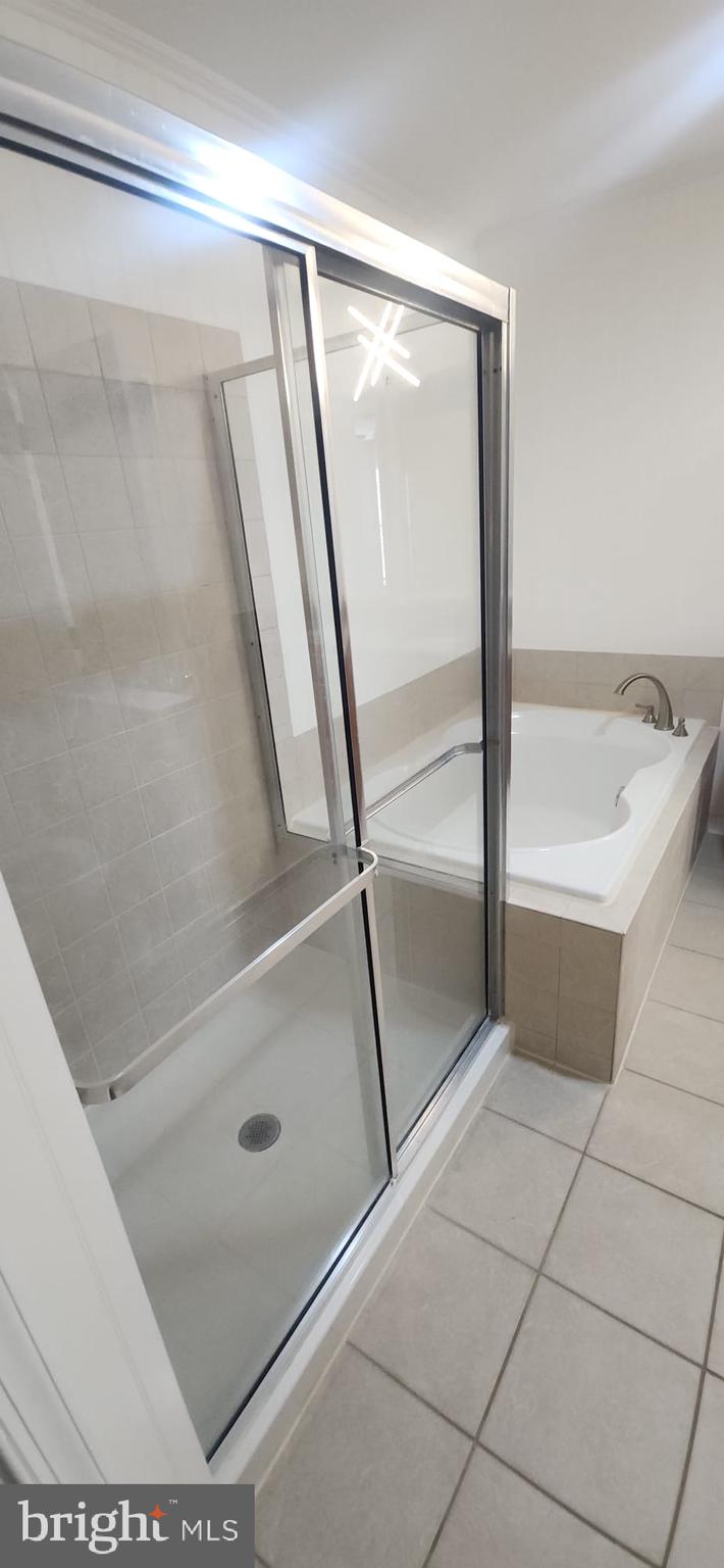 107 Swallow Pointe Court Frederick, MD 21702 - Photo 3 of 18 a bathroom with a glass shower door