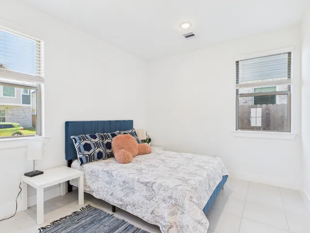 a bedroom with a bed and window