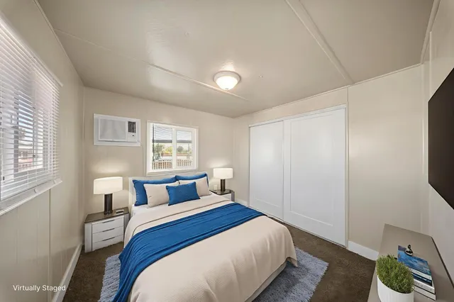 a bedroom with a bed and a window