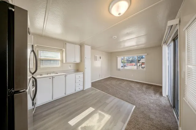 a kitchen with a refrigerator and a sink