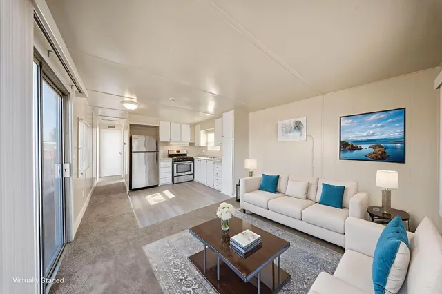 a living room with furniture and kitchen view