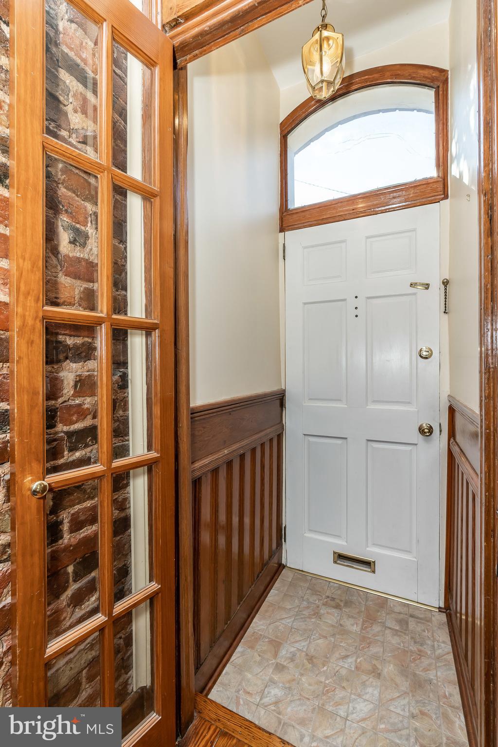 Entry foyer w wainscotting.