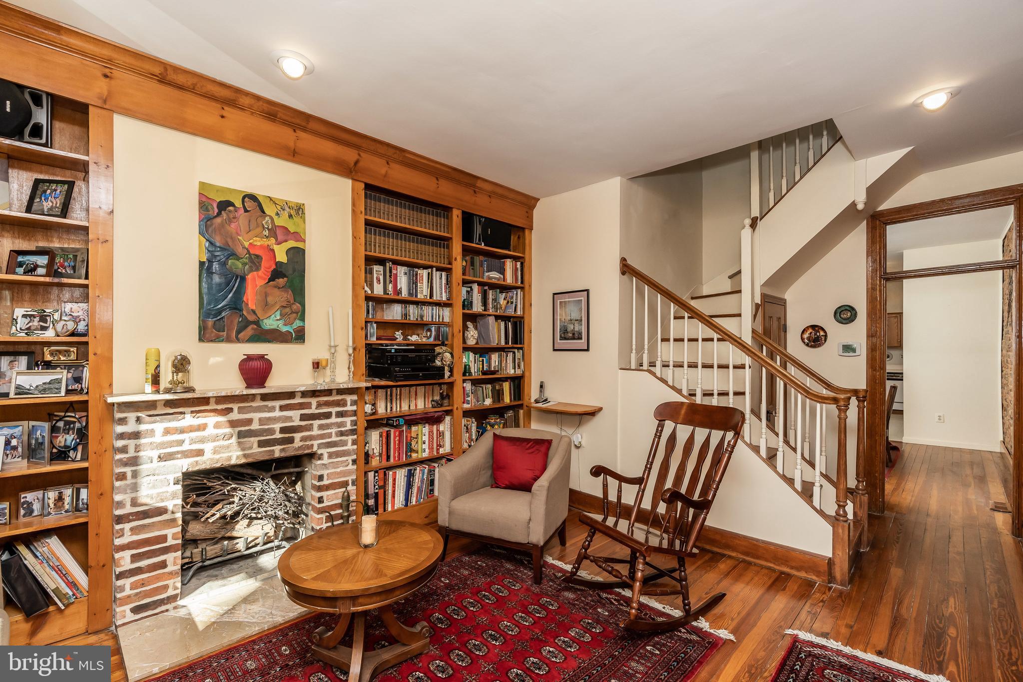 Built-ins flank wood burning fireplace.