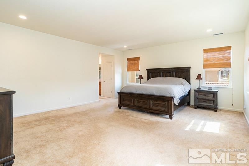 475 Stradella Court Reno, NV 89521 - Photo 12 of 22 a spacious bedroom with a bed and a window