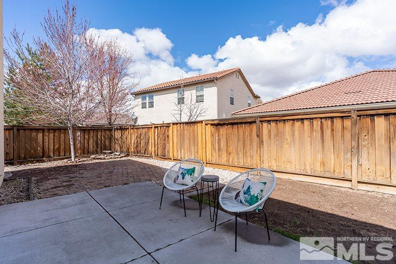 475 Stradella Court Reno, NV 89521 - Photo 21 of 22 a view of a chairs and table in the back yard of a house