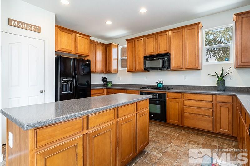 475 Stradella Court Reno, NV 89521 - Photo 6 of 22 a kitchen with stainless steel appliances granite countertop a refrigerator a sink dishwasher stove and oven