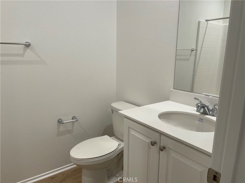 349 Lilly Street Rialto, CA 92376 - Photo 17 of 25 a bathroom with a sink toilet and a mirror