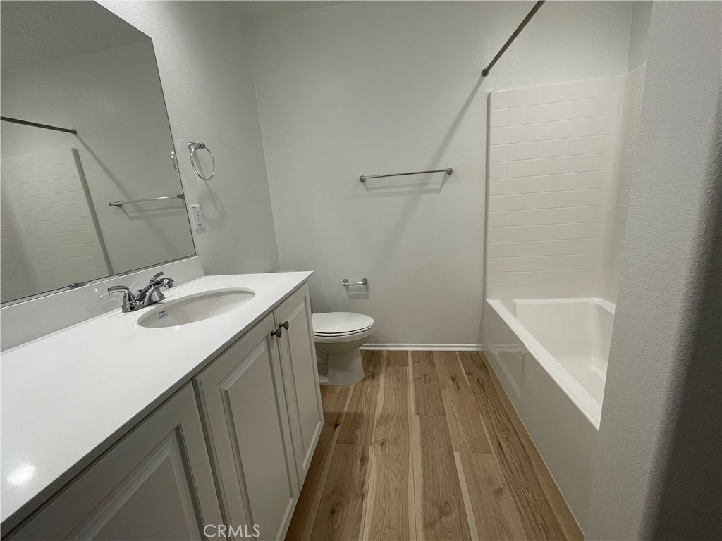 349 Lilly Street Rialto, CA 92376 - Photo 18 of 25 a bathroom with a sink a toilet a shower and a mirror