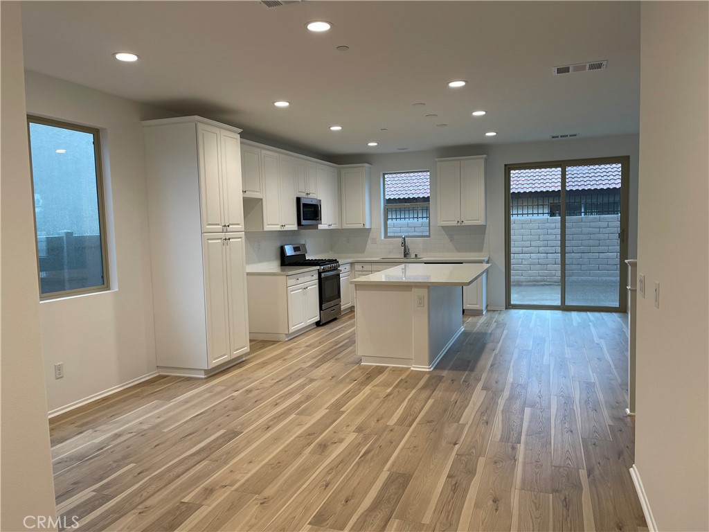 349 Lilly Street Rialto, CA 92376 - Photo 5 of 25 a kitchen with a sink stainless steel appliances and cabinets