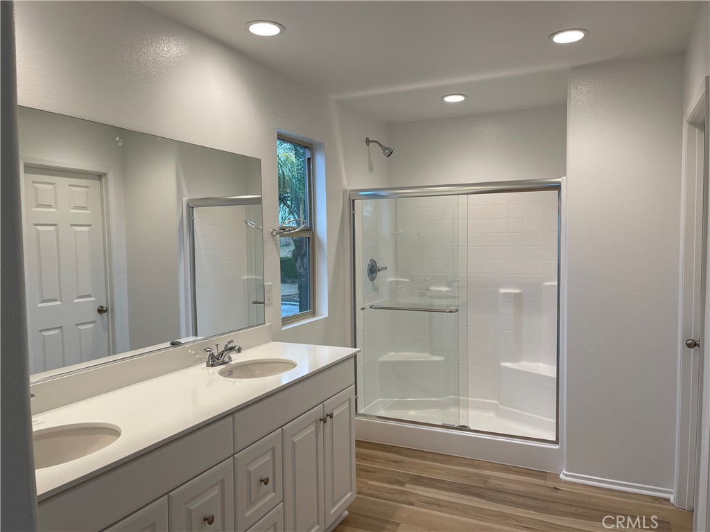 349 Lilly Street Rialto, CA 92376 - Photo 8 of 25 a bathroom with a shower sink vanity and mirror