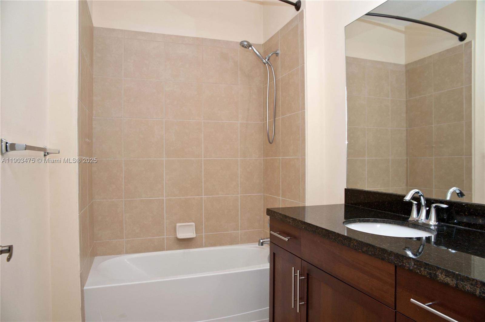 14620 Southwest 15th Street Pembroke Pines, FL 33027 - Photo 12 of 59 a bathroom with a granite countertop bathtub shower sink vanity and a mirror