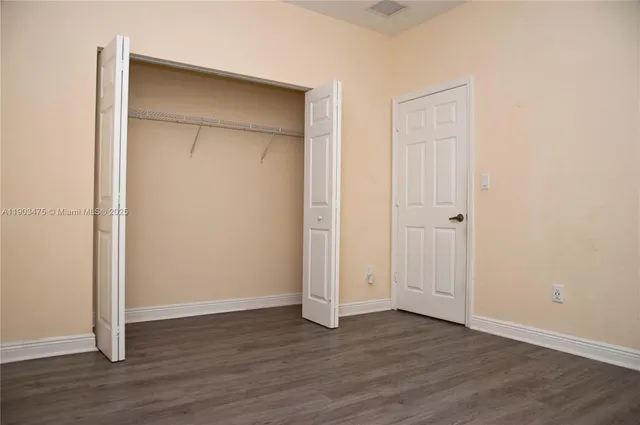 a kitchen with granite countertop a sink and cabinets