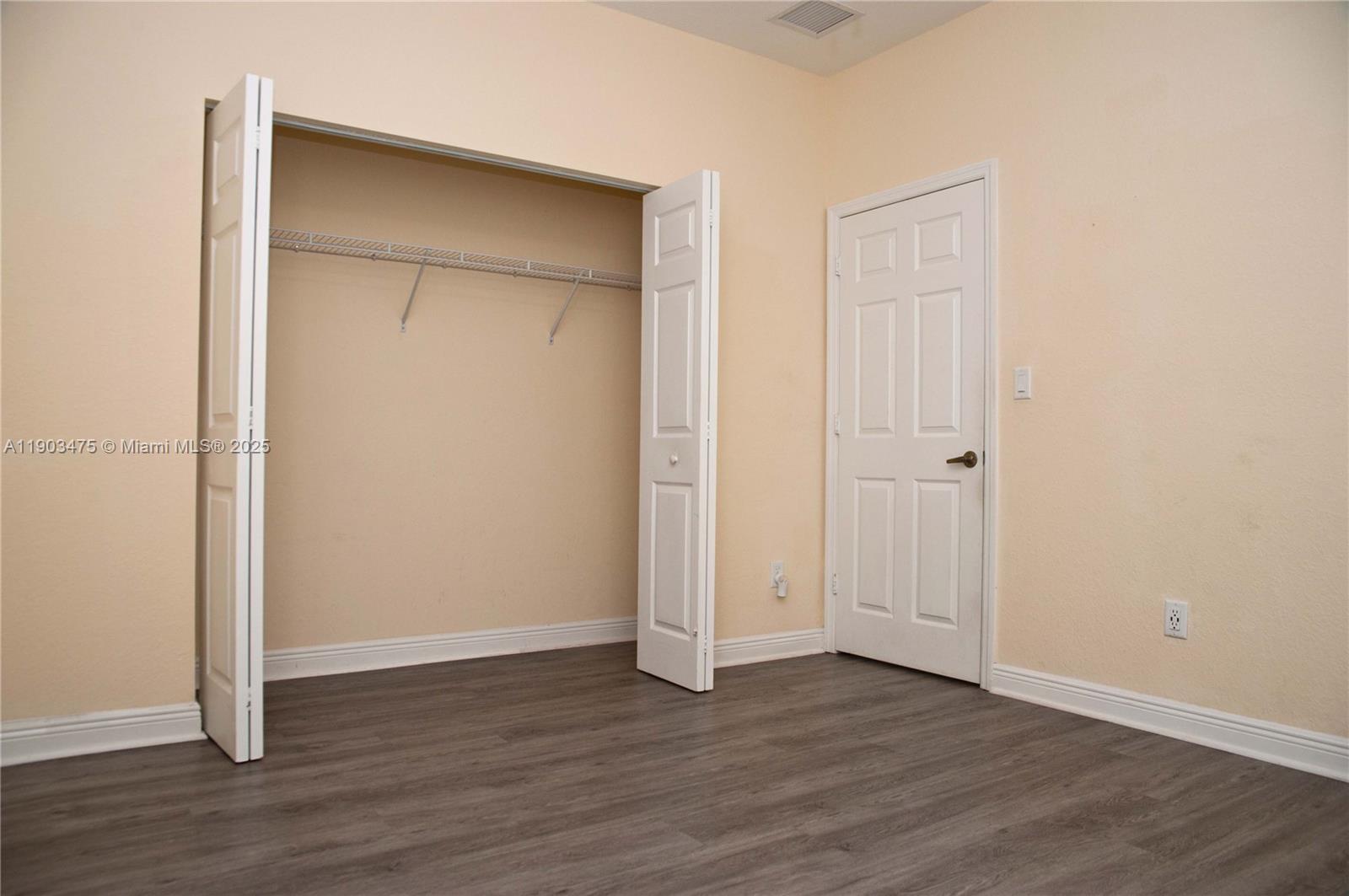 14620 Southwest 15th Street Pembroke Pines, FL 33027 - Photo 14 of 59 an empty room with wooden floor and closet