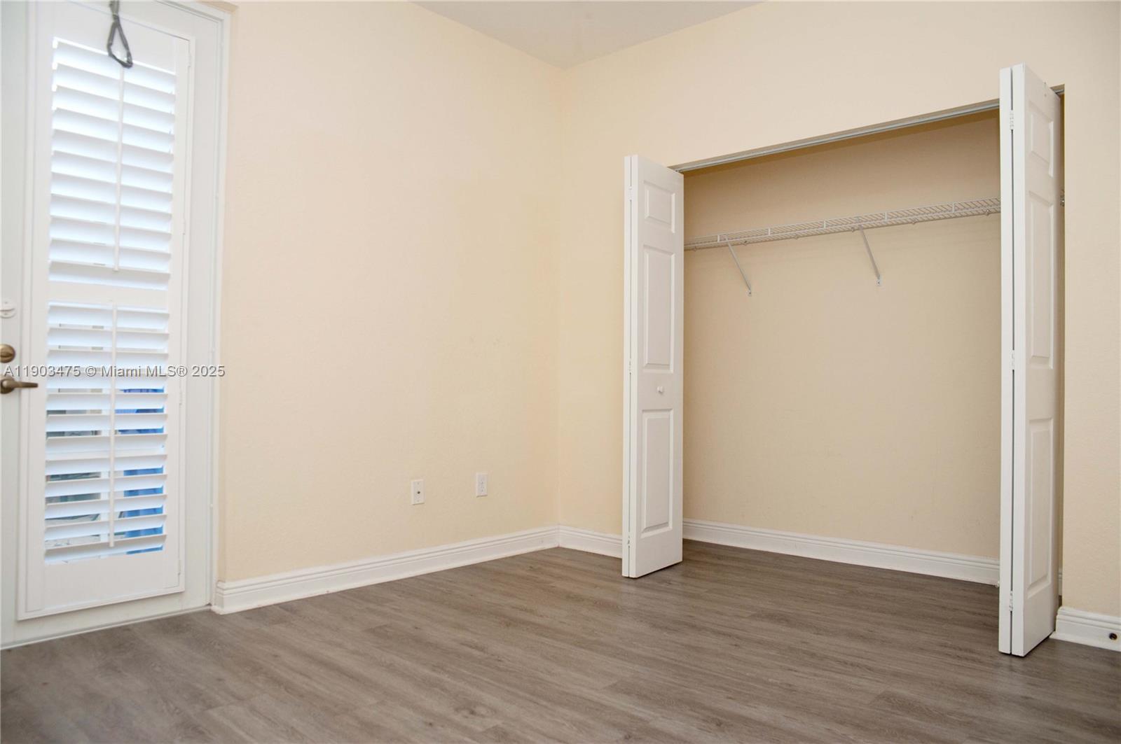14620 Southwest 15th Street Pembroke Pines, FL 33027 - Photo 15 of 59 a view of an empty room with wooden floor and a window